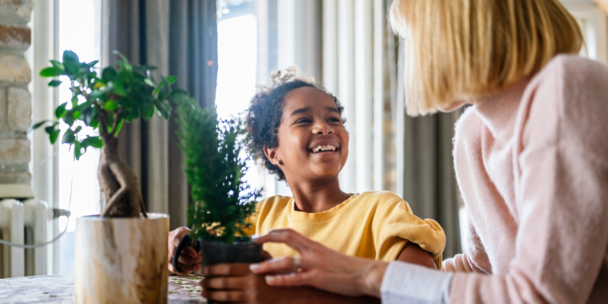 Parent and child exploring plant science together, demonstrating home-based learning about plant communication and biological processes