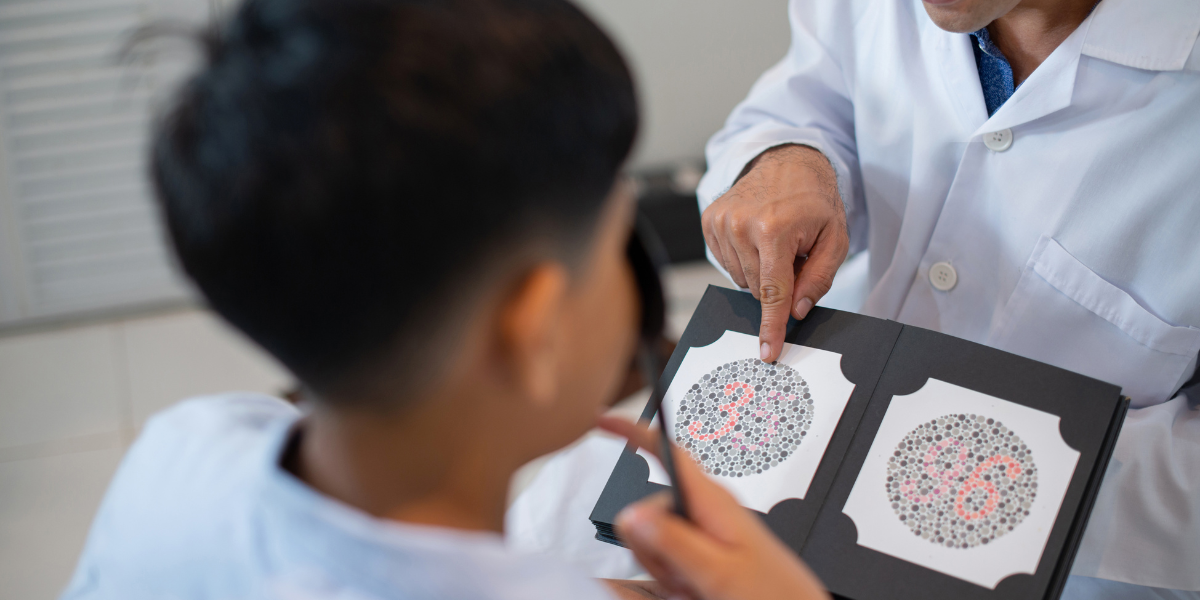 Eye care professional conducting colour blindness assessment with young patient using specialized testing materials in clinical setting for proper diagnosis