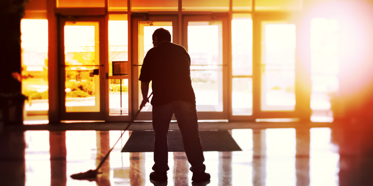 Stadium worker cleaning floors showing wage differences in sports industry