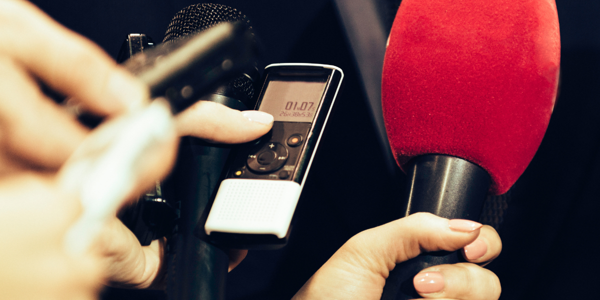 Digital recording devices and red microphone showing modern journalism equipment