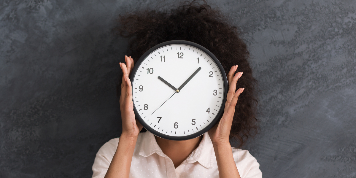 Woman holding clock over face demonstrating riddles that challenge your critical thinking beyond time concepts to focus on language patterns