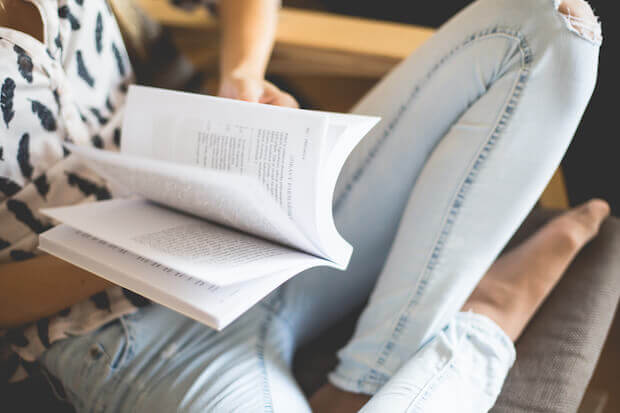 girl reading book - article on helping teens concentrate longer