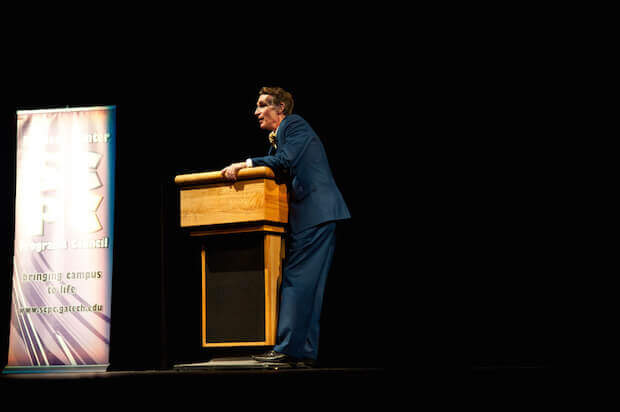 Bill Nye speaking on a podium - article image for teaching kids about modern day scientists