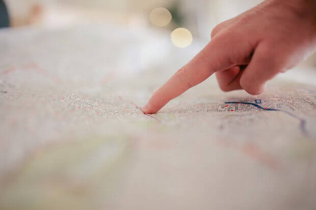 finger on a map - featured image for article on teaching kids about different types of maps