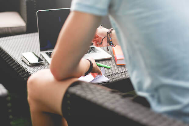 Using laptop on coffee table - article featured image for what is the flipped classroom model