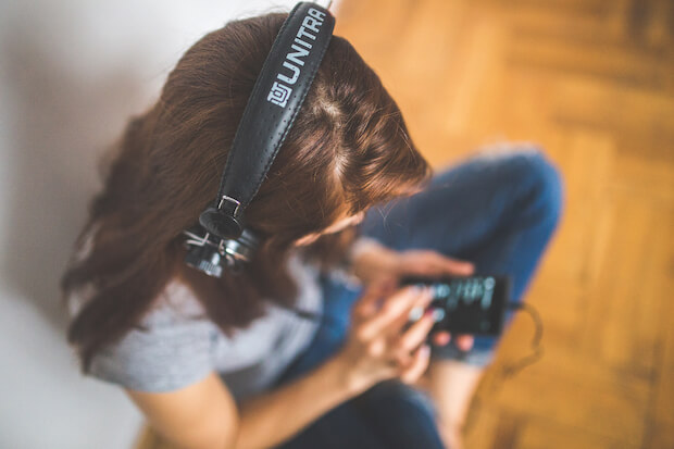 girl listening to music - featured image for how music heals students article