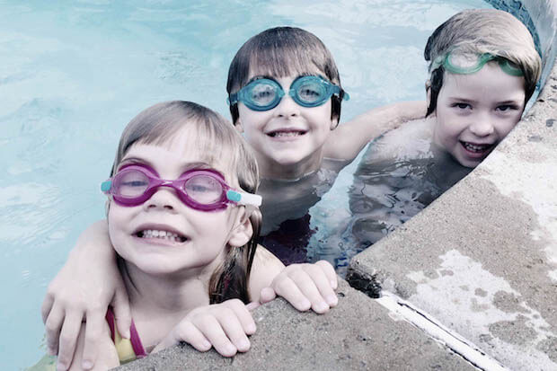 kids swimming with goggles - photo for article about benefits of extra curricular activities