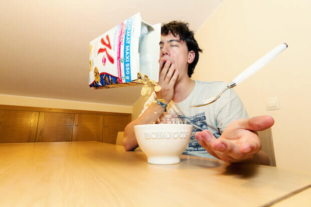 teen eating cereal - teaching kids about food waste featured image