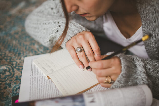 teach kids fact checking article image - girl taking notes 